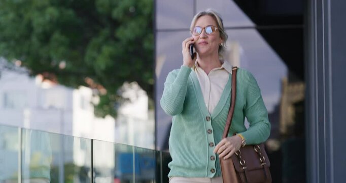 Business woman, walking and leaving work with phone call for auction schedule, appointment info or networking. Real estate agent, person and speaking to client on balcony for property viewing or sale