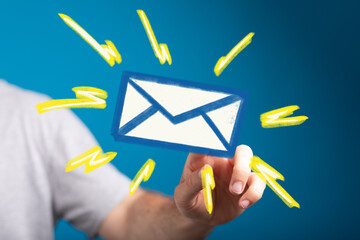 Image of a hand interacting with a digital email icon, surrounded by bright yellow strokes. Perfect...