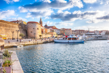 Unbelivable summer view of the Alghero Marina yacht port at the Gulf of Alghero with anchored sailboats.