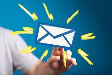 Hand holding email icon, signifying online communication and message receiving.