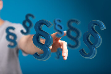 Abstract image of a hand interacting with floating paragraph symbols, representing digital law,...