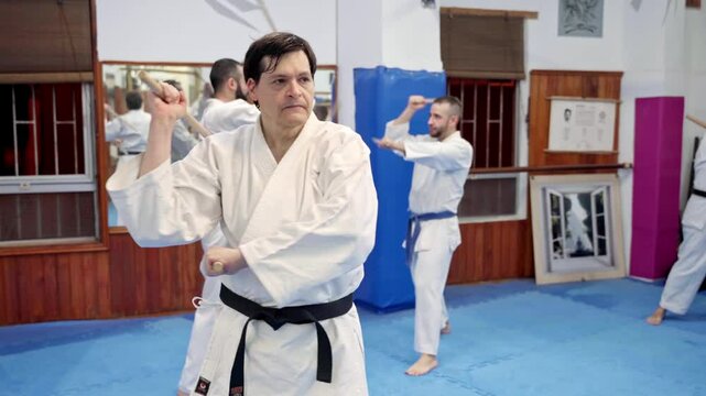 Aikido master practicing jo staff techniques in dojo