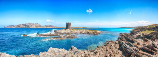Unbelivable morning view of famous La Pelosa beach and rocky shore near Torre della Pelosa