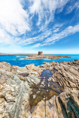 Unbelivable morning view of famous La Pelosa beach and rocky shore near Torre della Pelosa