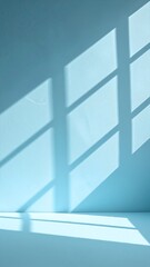 A textured white wall illuminated by soft, diffused light, casting gentle shadows that create an intriguing interplay of light and dark patterns.