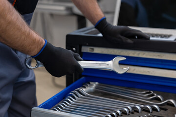 Mechanic working with tools and laptop