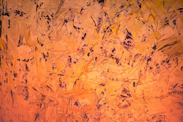 Abstract background in bright orange color from chaotic brush strokes.