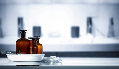 Medicine Bottles on Table – Doctor’s Office in Background. Medical consultation room and...