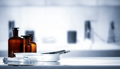 Medicine Bottles on Table – Doctor’s Office in Background. Medical consultation room and...