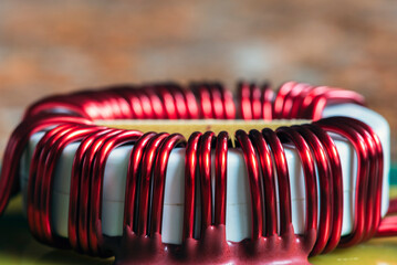 Copper coil on an electronic board, close-up view
