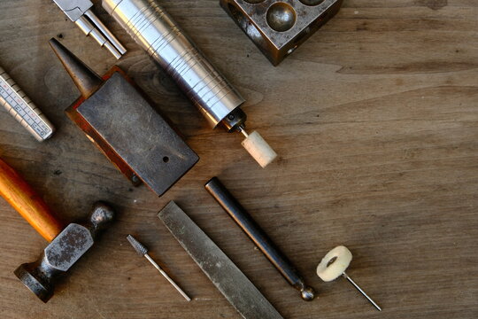 Jeweler's workplace. Top view of jeweler's workbenche with different tools on a wooden table. Goldsmith concept background