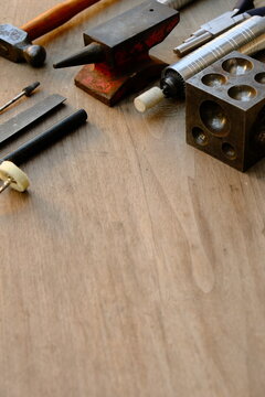 Jeweler's workplace. Top view of jeweler's workbenche with different tools on a wooden table. Goldsmith concept background