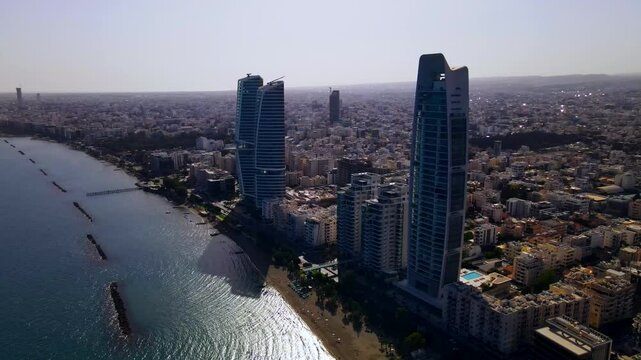 Evening sunset over Limassol, Cyprus. Aerial view of modern urban architecture and glass skyscrapers of Cyprus. Mediterranean Sea near Limassol, Cyprus. High quality footage 4k