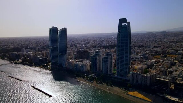 Evening sunset over Limassol, Cyprus. Aerial view of modern urban architecture and glass skyscrapers of Cyprus. Mediterranean Sea near Limassol, Cyprus. High quality footage 4k