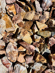 rocks in different shapes and colors in brown and yellow tones filling the frame