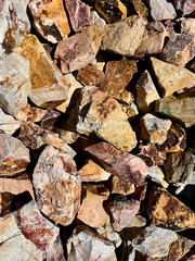 rocks in different shapes and colors in brown and yellow tones filling the frame