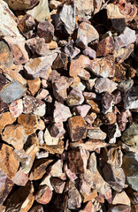 rocks in different shapes and colors in brown and yellow tones filling the frame