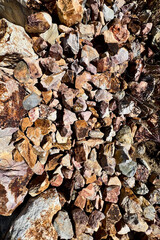 rocks in different shapes and colors in brown and yellow tones filling the frame