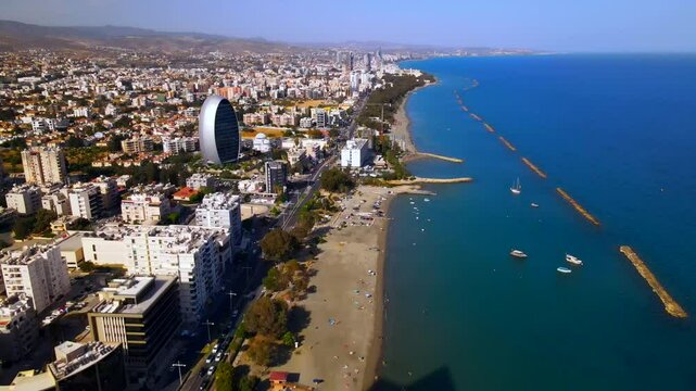 Evening sunset over Limassol, Cyprus. Aerial view of modern urban architecture and glass skyscrapers of Cyprus. Mediterranean Sea near Limassol, Cyprus. High quality footage 4k
