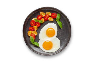 Fried eggs and Caprese salad with tomatoes, mozzarella cheese and basil leaves in a plate. Top view.