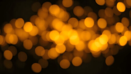 Obraz premium Abstract golden bokeh lights on a dark background for festive celebration