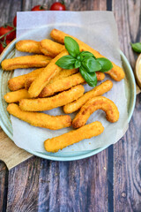 Crispy  deep fried home made    chicken strips Breaded  with  almond flour chicken  breast fillets  with chilly peppers and fresh   basil on wooden rustic background. Ketogenic diet food