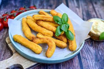 Crispy  deep fried home made    chicken strips Breaded  with  almond flour chicken  breast fillets  with chilly peppers and fresh   basil on wooden rustic background. Ketogenic diet food