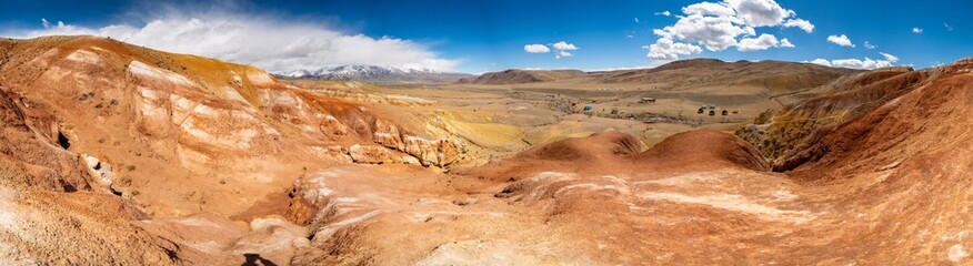 Panoramic view of red and yellow mountains with canyons and gorges at Mars Altai Russia. Popular tourist destination showcasing unique colorful geological formations.
