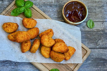 
 Crispy oven baked  chicken nuggets and  barbeque sauce . Breaded chicken fillets  with chilly...