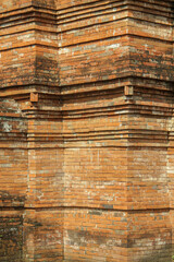 Close-up of an ancient brick wall corner with layered architectural design and weathered texture, showcasing traditional craftsmanship and historical detail.