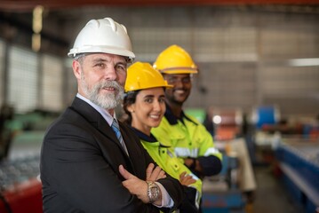 mature older boss engineer with beard mustache on face wear helmet standing smile and hand show...