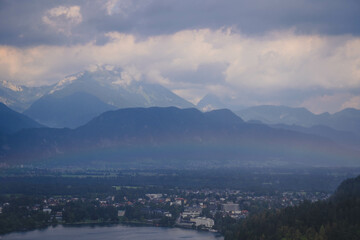 Fototapeta premium panorama of the mountains with rainbow after the rain and cloudy mood