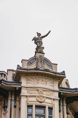 detail of tower and facade with big statue in european city