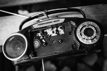 Vintage portable cassette recorder with broken deck in black and white style.