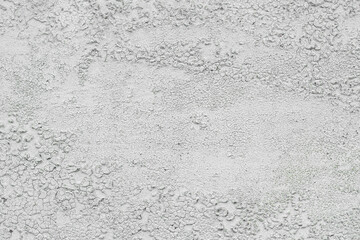 White cracked textured surface resembling dried mud or aged plaster for background.