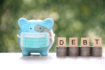 Piggy bank attached to the plaster on the head and stack of coins money on green background, Save money for Medical insurance and Health care concept