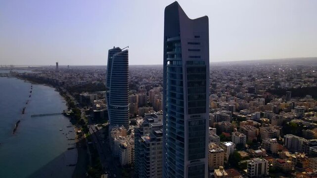 Evening sunset over Limassol, Cyprus. Aerial view of modern urban architecture and glass skyscrapers of Cyprus. Mediterranean Sea near Limassol, Cyprus. High quality footage 4k
