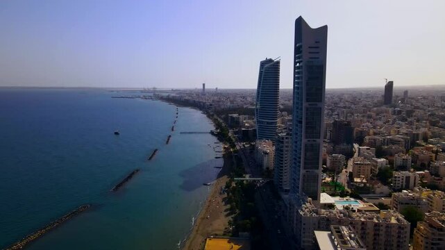Evening sunset over Limassol, Cyprus. Aerial view of modern urban architecture and glass skyscrapers of Cyprus. Mediterranean Sea near Limassol, Cyprus. High quality footage 4k