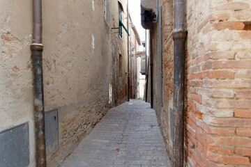 Hidden alley in Peccioli village, province of Pisa . Tuscany, Italy