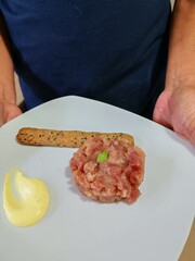 Close-up of tuna tartare dish. Raw fish appetizer. Tuna tartare tasty and refined dish, appetizer second course, dinner between two friends or couple for a special occasion. Easy and tasty recipe