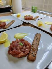 Close-up of tuna tartare dish. Raw fish appetizer. Tuna tartare tasty and refined dish, appetizer second course, dinner between two friends or couple for a special occasion. Easy and tasty recipe