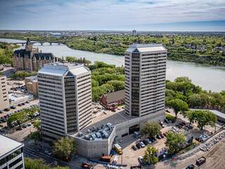City with two tall buildings and a river in the background