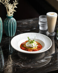 Portion of gourmet italian breakfast with mozzarella tomatoes and poached egg
