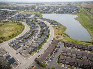 Residential area with houses and a lake in the background