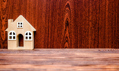 House symbol on a brown wooden background
