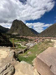 Ancient Inca ruins and stone fortifications at Ollantaytambo, Peru, showcasing impressive pre-Columbian architecture set against the dramatic Andes Mountains. A historic archaeological site rich in cu