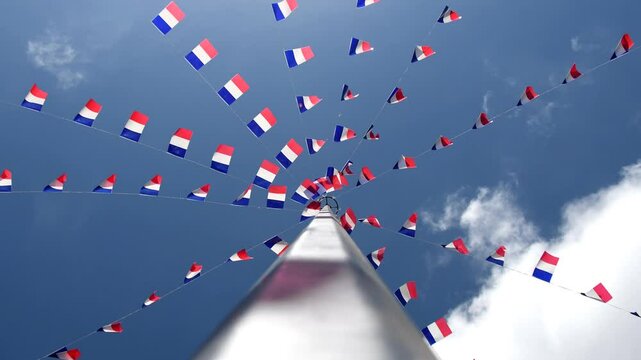 French flags and bunting blowing in the wind against a blue sky background. French and France concept video.