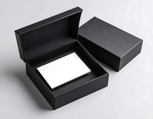 Black rectangular box with lid ajar, showcasing a blank white card inside