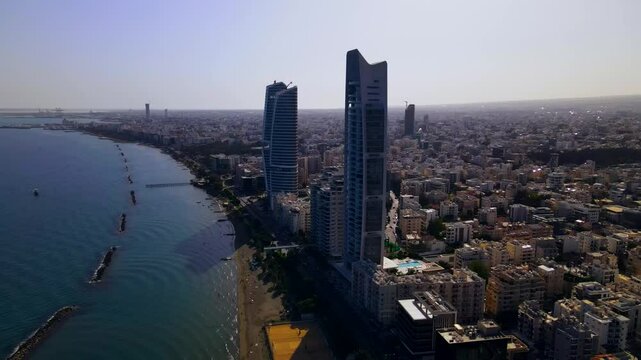 Evening sunset over Limassol, Cyprus. Aerial view of modern urban architecture and glass skyscrapers of Cyprus. Mediterranean Sea near Limassol, Cyprus. High quality footage 4k