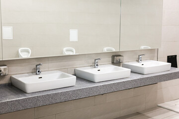 Large public men's toilet with white.